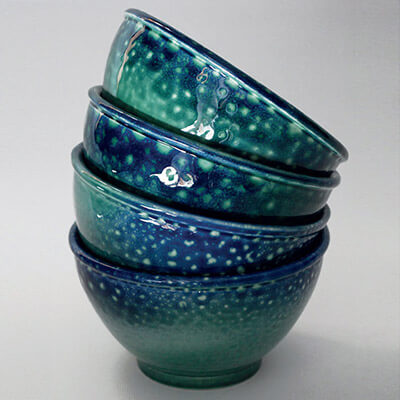 stack of four small glazed bowls