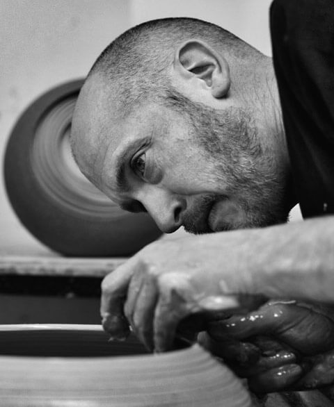 Matthew Chambers working on a ceramic piece on the potters wheel